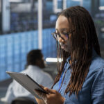 engineer server room using tablet implement data backup solutions scaled 1