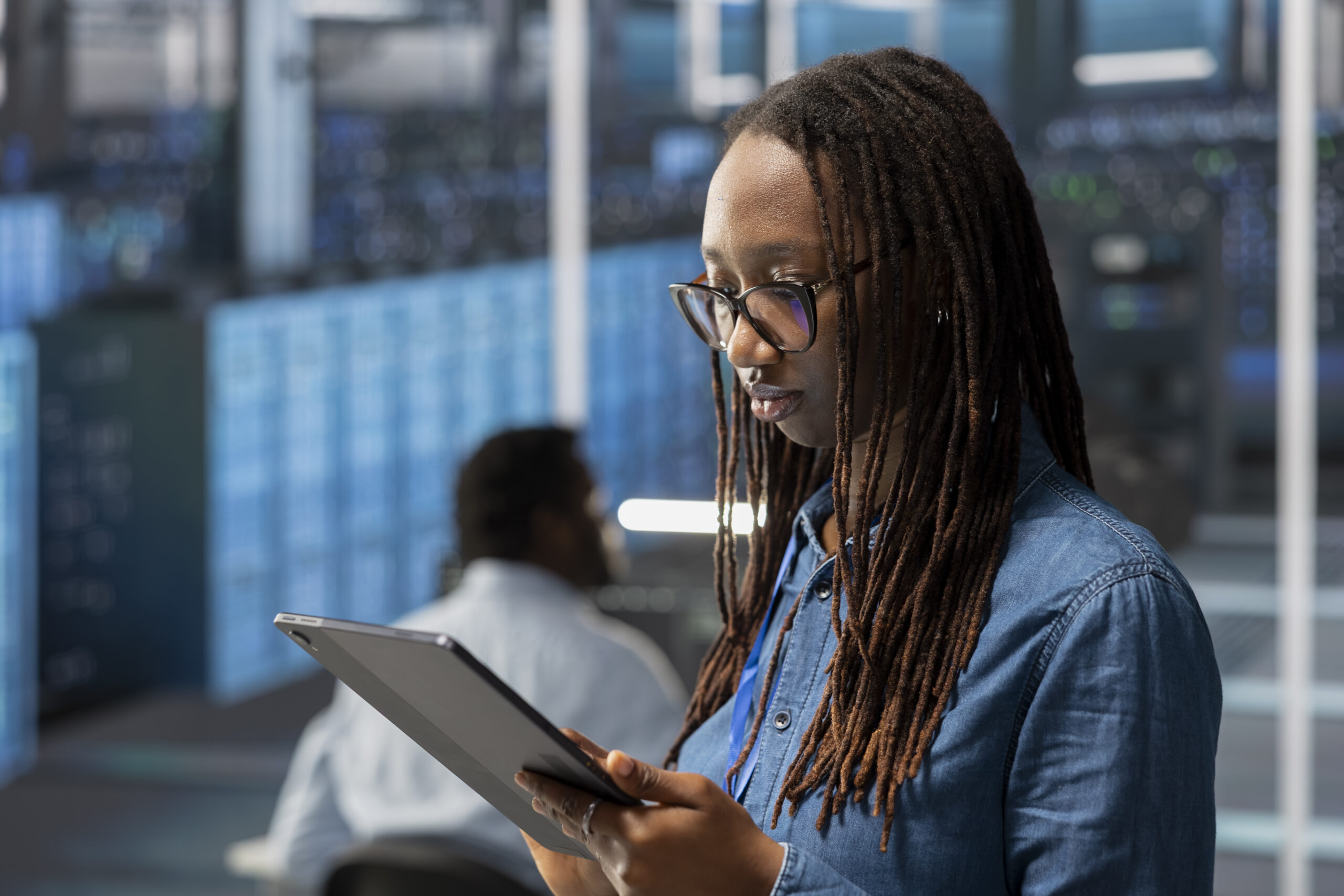 engineer server room using tablet implement data backup solutions scaled 1