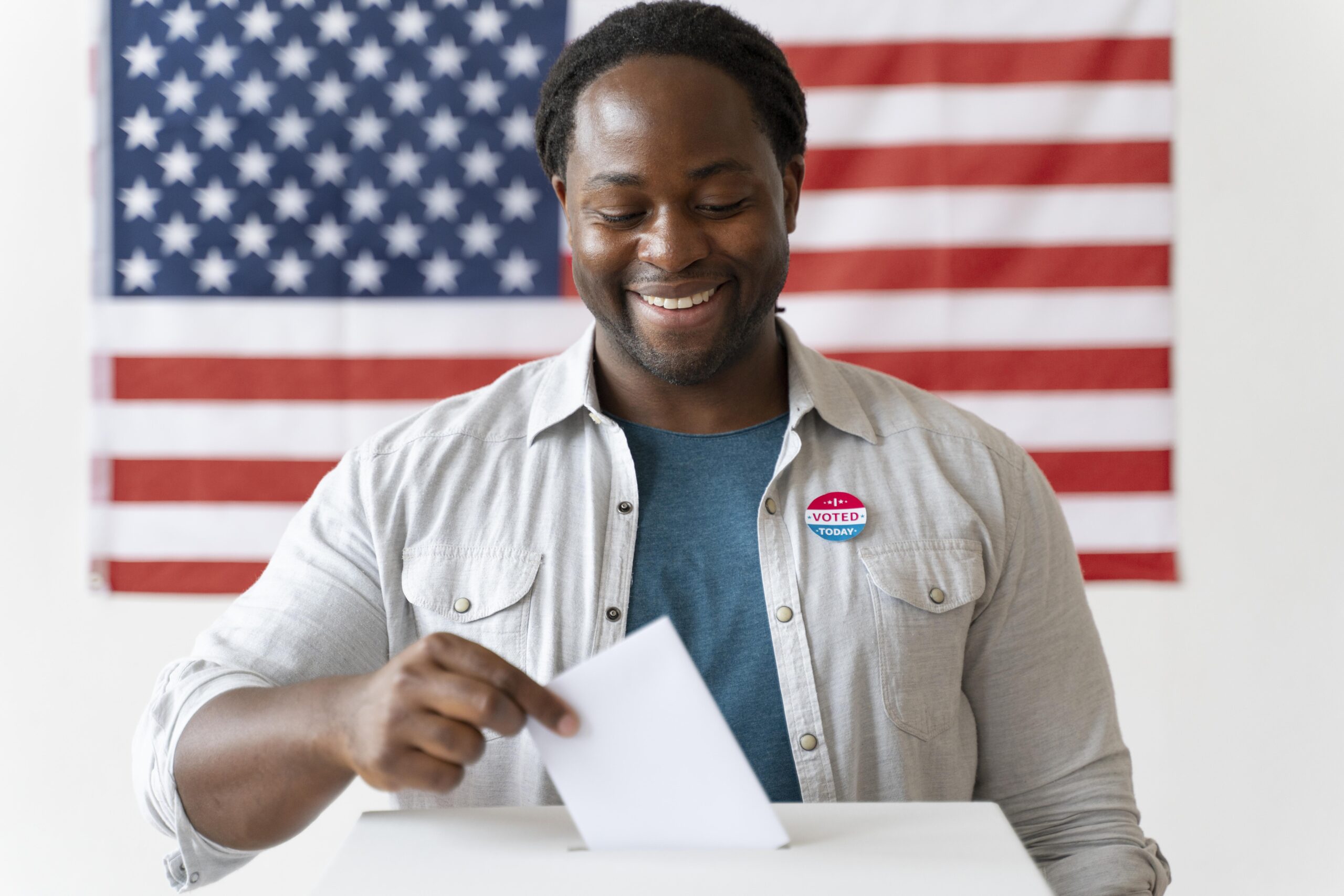 A black man checking a document with a U.S. flag at the background.